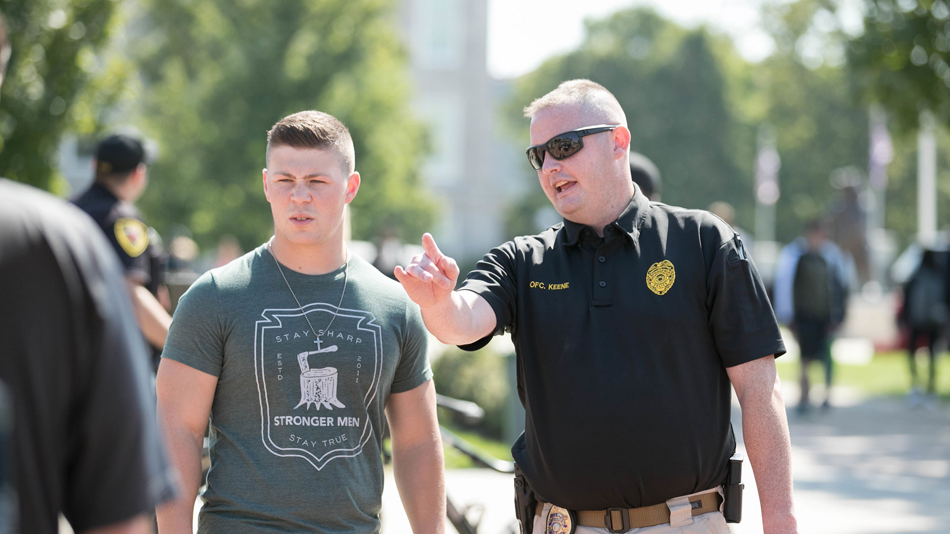 Police officer talking to student during Cops on Campus event.