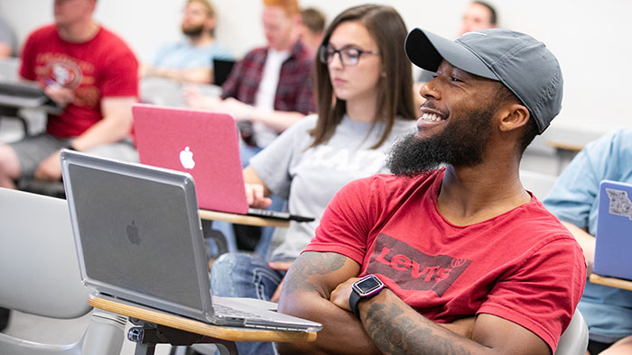 Student in seated criminology class. 