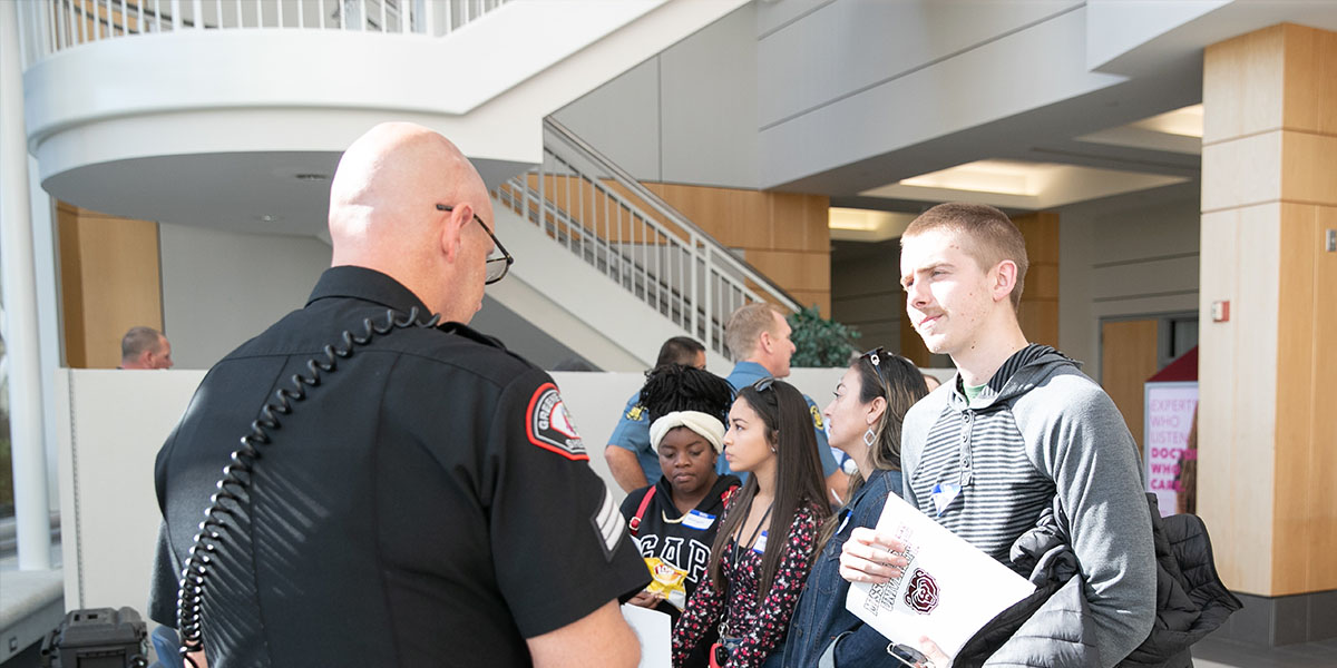 MSU Student converses with Springfield police officer.