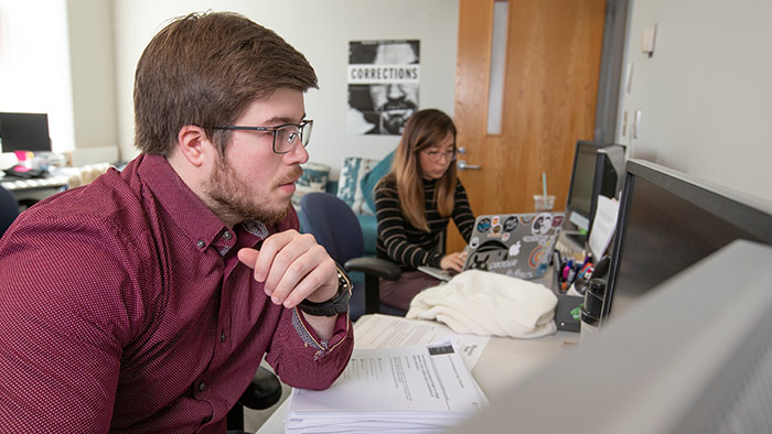 Criminology students studying in office.