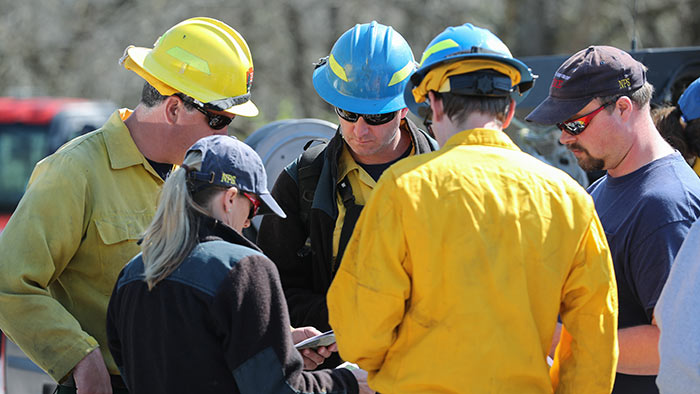 Park rangers and fire fighters going over plans for prescribed burns.