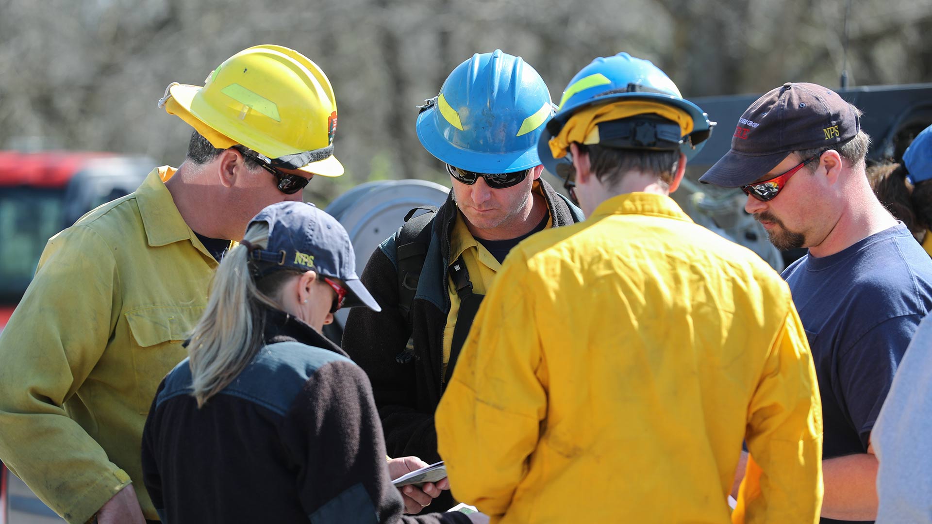 Park rangers and fire fighters going over plans for prescribed burns.