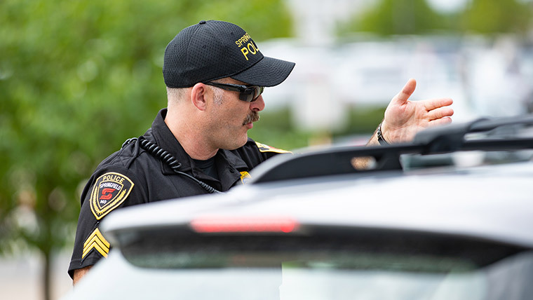 Police officer giving instructions to driver.